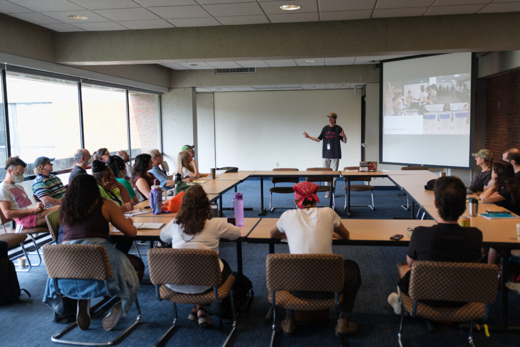 CPE Director leading an activity in a classroom filled with seated participants